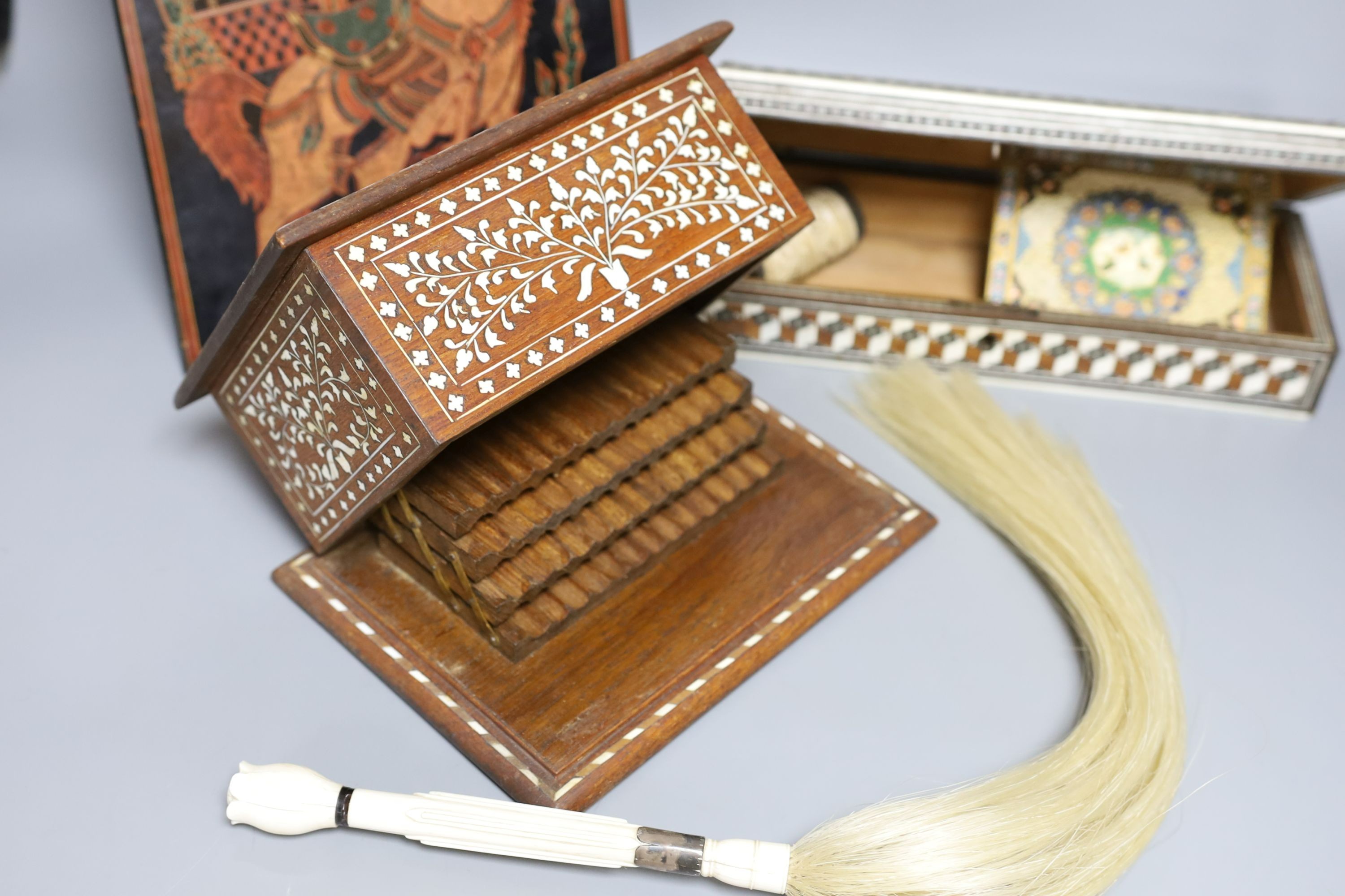 A 19th century ivory handled fly whisk, ivory inlaid sandalwood glove box, carved bone snuff box, bone inlaid cigarette box, a Burmese lacquer panel and a Persian painted ivorine panel